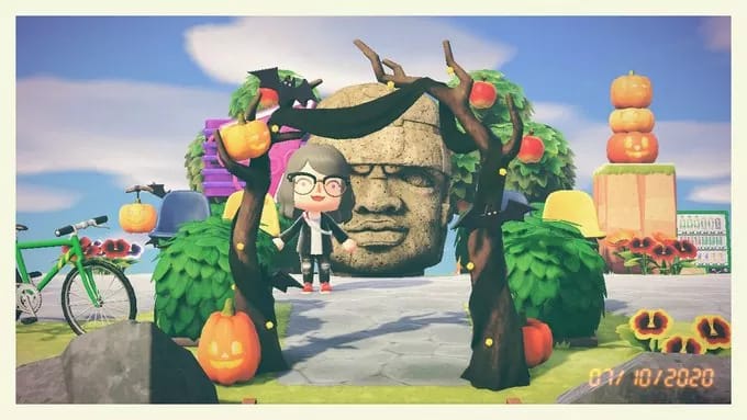 "A character from the game animal crossing standing underneath a wooden arch with pumpkins dotted around. Also Animal Crossing isn't friendslop for reasons I didn't really have space to cover in this essay, which is fine! Just also weird given that it's proximity to friendslops origins")